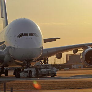 A380 ist being towed at the airport at sundown